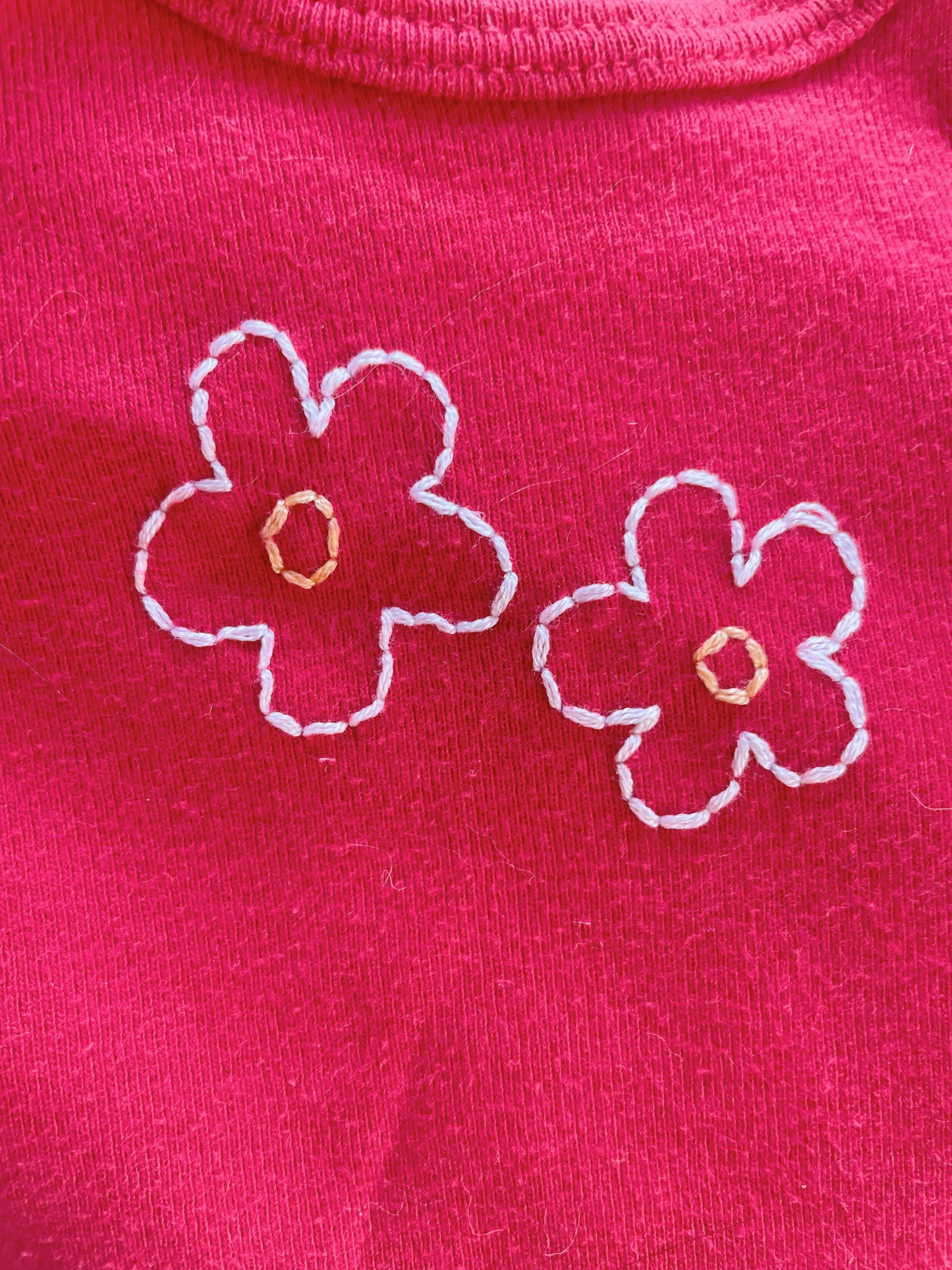 Flowers Hand embroidered on thrifted onesies